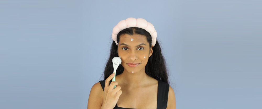 Woman applying skincare with the Lunaescent touch-free applicator